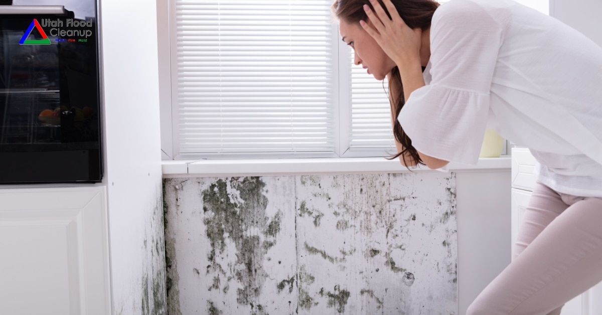 Woman covering nose due to smell in moldy home