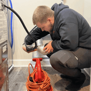 Technician cleaning dryer vent to prevent house fires