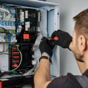 Electrician inspecting household wiring to prevent electrical fires