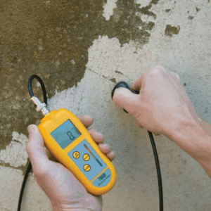 Moisture meter detecting mold risk inside wall