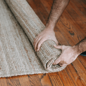Pulling up soaked carpet after water damage